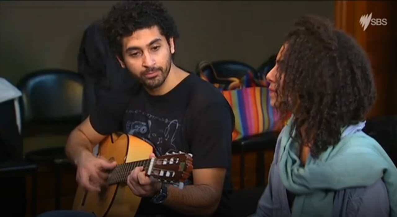 A still of Mr Sami playing the guitar (SBS)