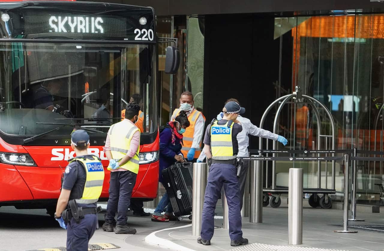 Recently arrived overseas travellers arrive at the Crown Promenade Hotel in Melbourne.