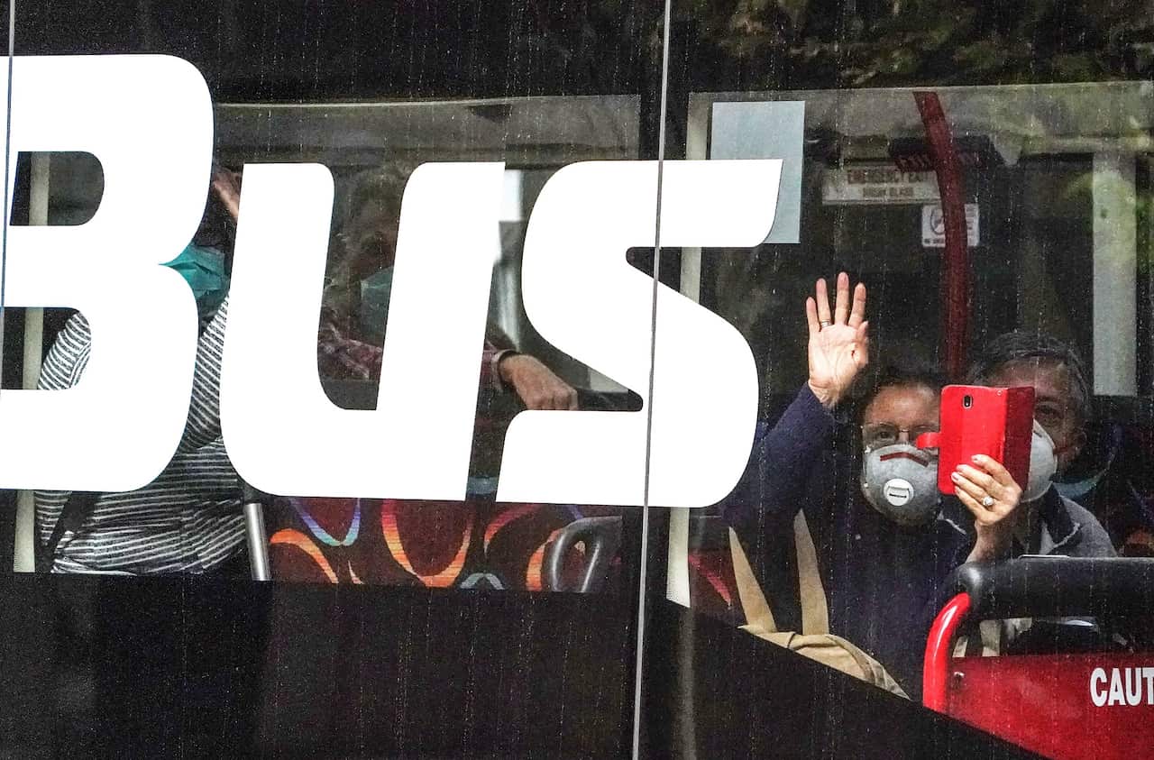 Recently arrived overseas travellers arrive at the Crown Promenade Hotel in Melbourne for a mandatory 14-day quarantine period.