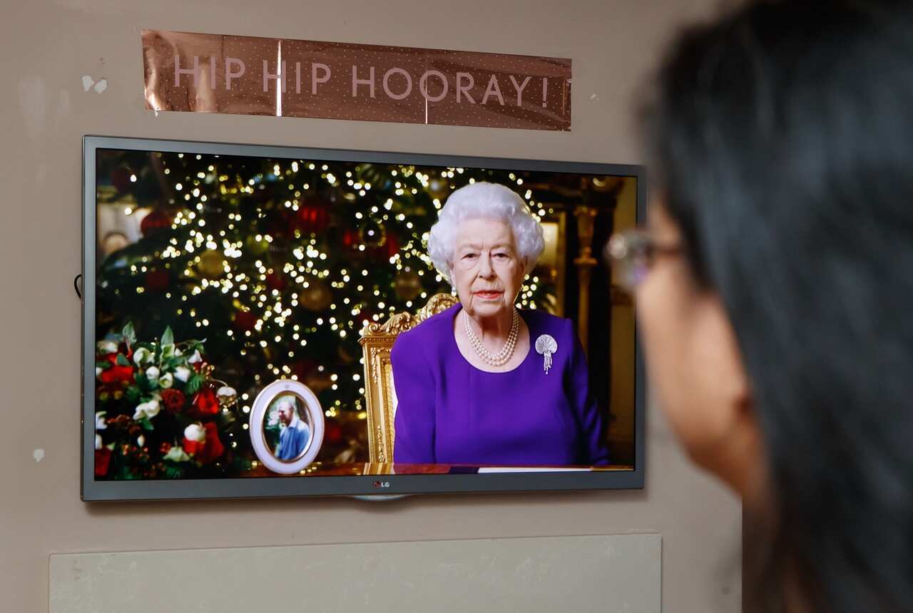 A woman watches the Queen Elizabeth II's speech from her home in Leeds. 