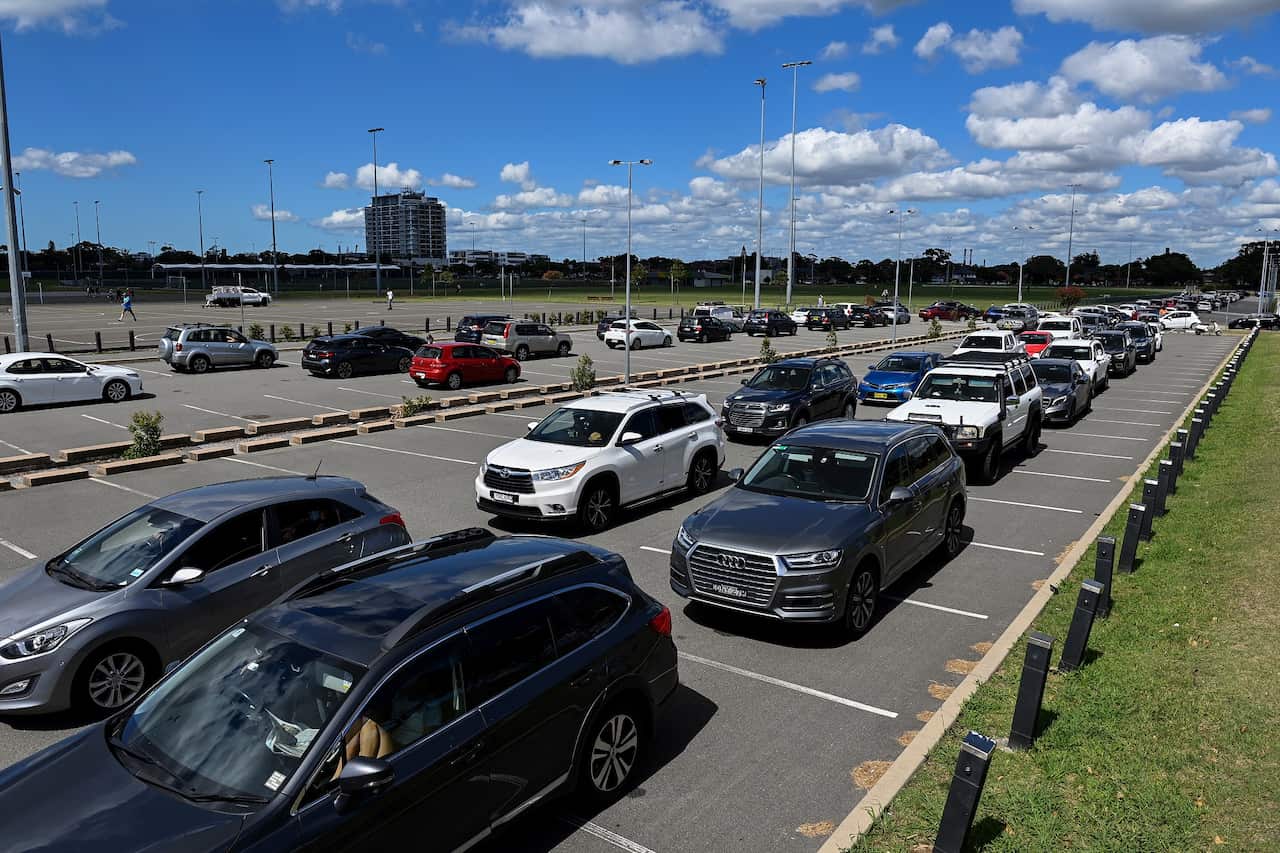 Members of the public queue in their cars for a COVID-19 PCR test at Sydney drive-through clinic. 