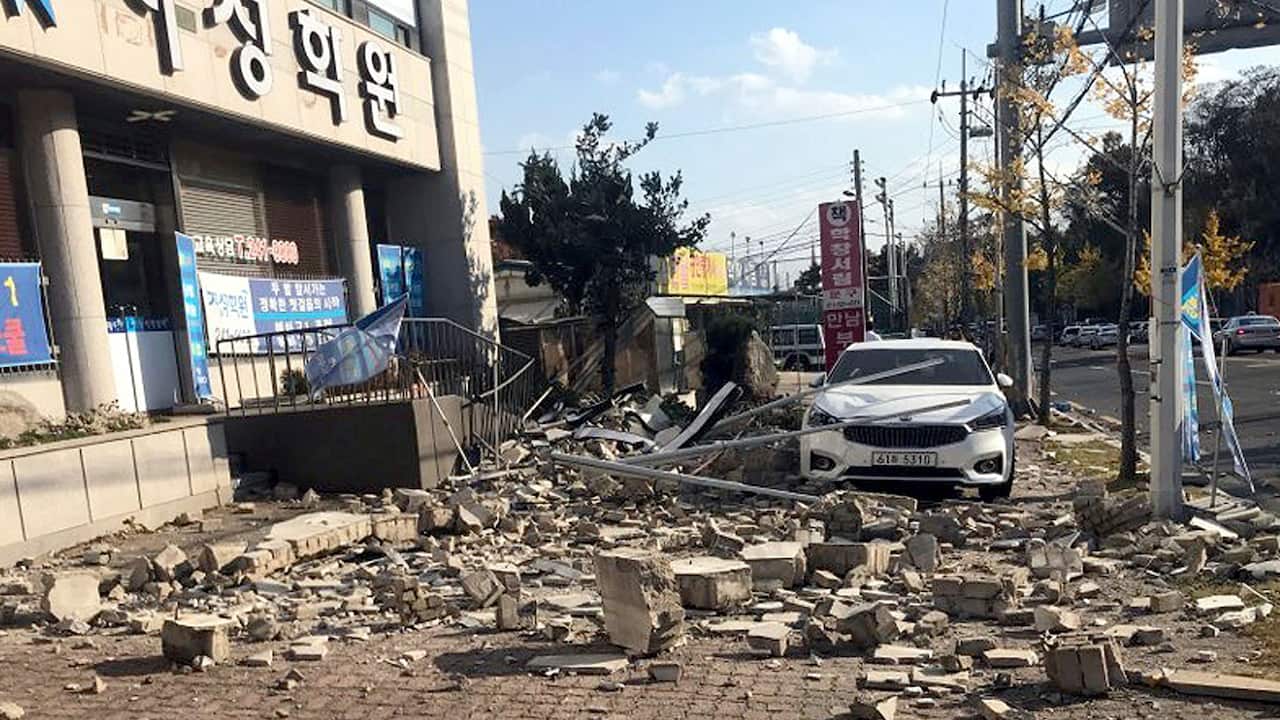 Debris from a collapsed wall is scattered in front of a shop after an earthquake in Pohang, South Korea.