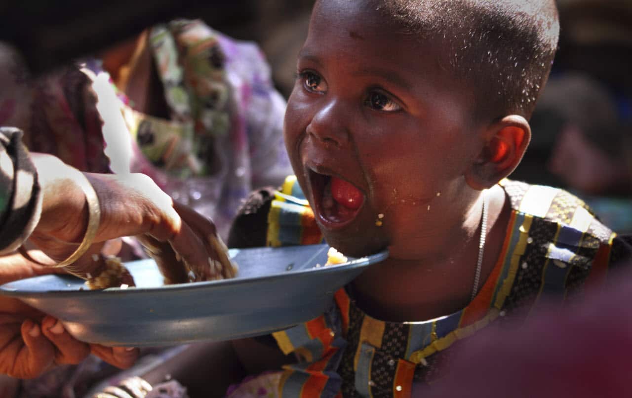 A newly arrived Rohingya refugee mother feeds her daughter at a transit camp in Nayaprar refugee camp near Cox's Bazar, Bangladesh.