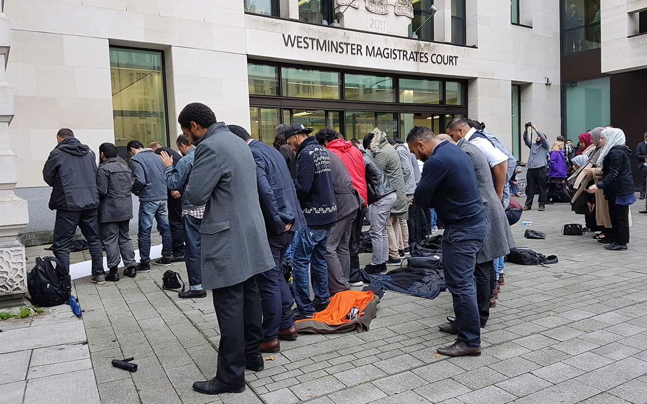 People pray outside Westminster Magistrates Court, where the director of campaign group Cage Muhammad Rabbani faced court in September.