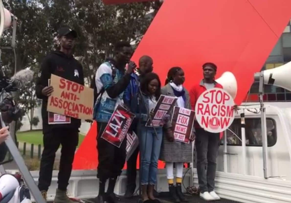 Protest organisers address the crowd outside Channel 7's office in Melbourne.