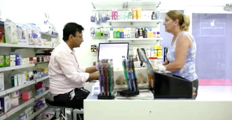 Pharmacist Raj Gupta serving a customer at his Malua Bay pharmacy.