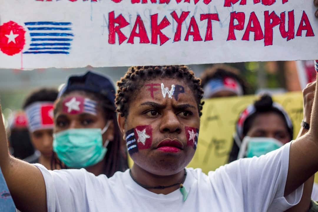 A Papuan student holds a banner which reads, 'Free Papuan People', during a rally in Surabaya, East Java, Indonesia.