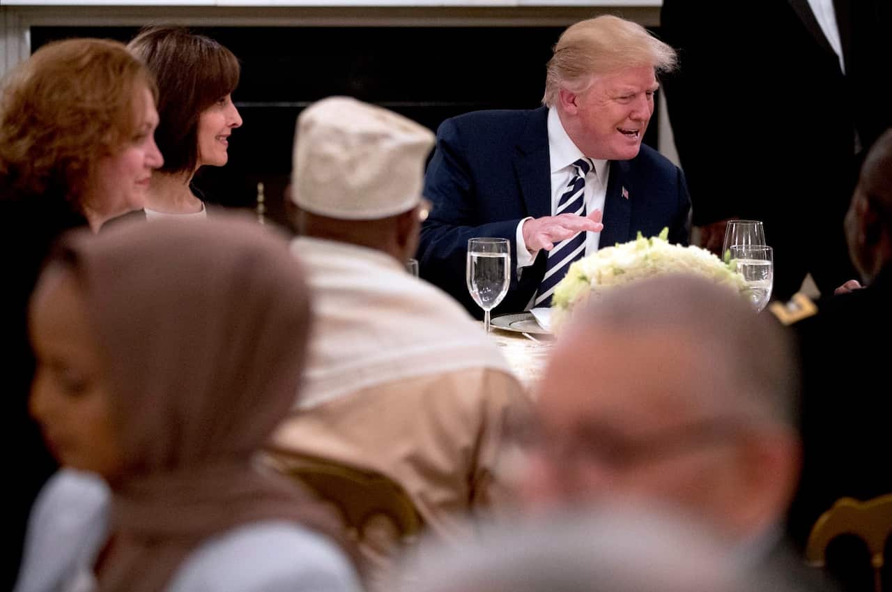 President Donald Trump sits down for an iftar dinner, which breaks a daylong fast, celebrating Islam's holy month of Ramadan, in the State Dining Room