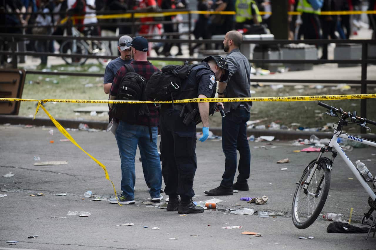 Toronto Police search for evidence after shots were fired during the Toronto Raptors NBA basketball championship parade in Toronto