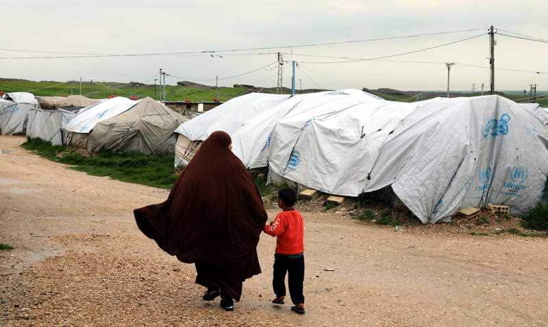 Refugees walk through a camp in Hasakah, northeast of Syria, following the final attack on IS.