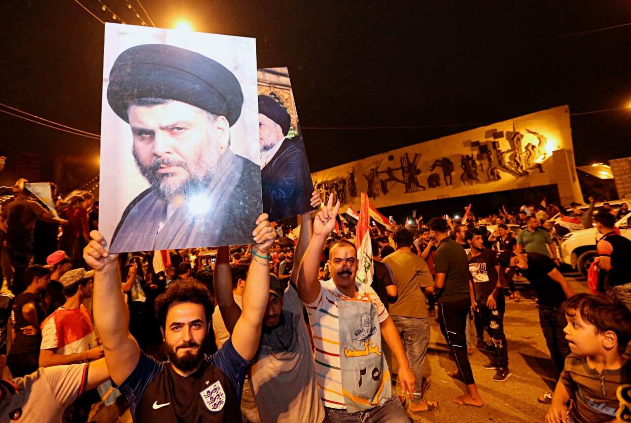 Followers of Shiite cleric Muqtada al-Sadr, seen in the posters, celebrate in Tahrir Square in Baghdad, Iraq, early Monday, May 14, 2018. 