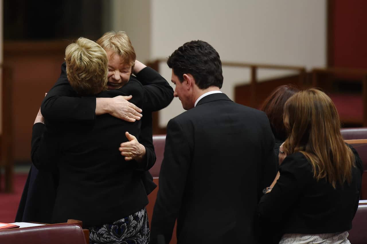Newly elected Australian Greens Senator Janet Rice (2L) is congratulated by Senator Christine Milne after delivering her maiden speech in the Senate chamber at Parliament House in Canberra, Wednesday, Aug. 27, 2014. (AAP Image/Lukas Coch) NO ARCHIVING