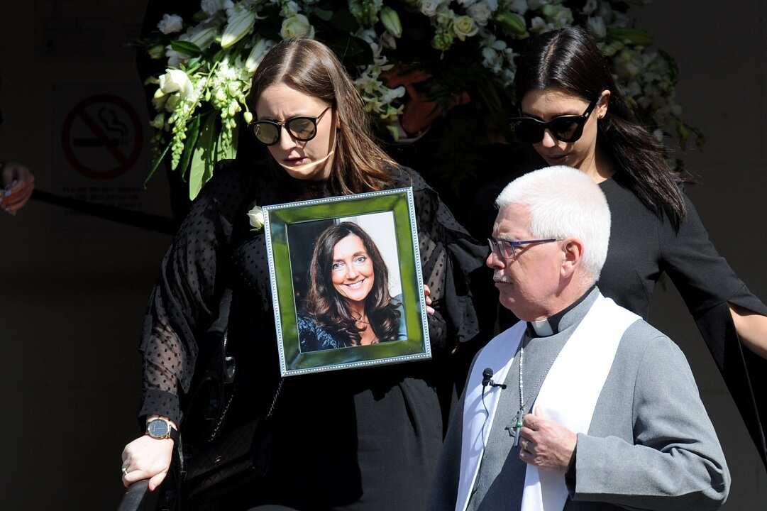 Daughter Sarah Ristevski carries a photo of her mother at her funeral in March earlier this year.