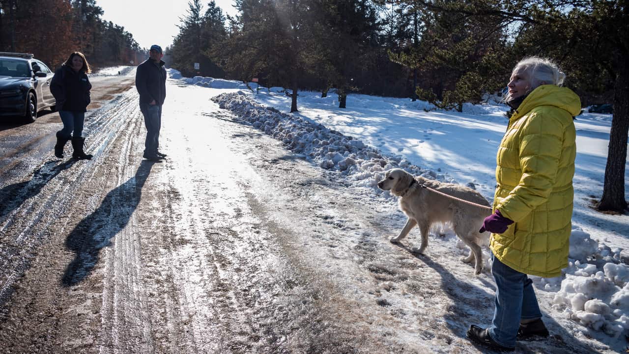 Kristin Kasinskas, left, husband, Peter, and Jeanne Nutter and her dog Henry head back to their homes after speaking with the media on 11/1/19.
