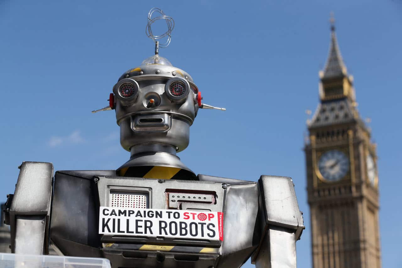 A robot distributes promotional literature calling for a ban on fully autonomous weapons in Parliament Square on April 23, 2013 in London, England. 