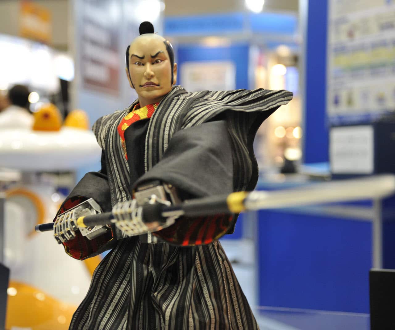 A samurai robot, produced by Japan's robot venture Crafthouse, lowers a spear.