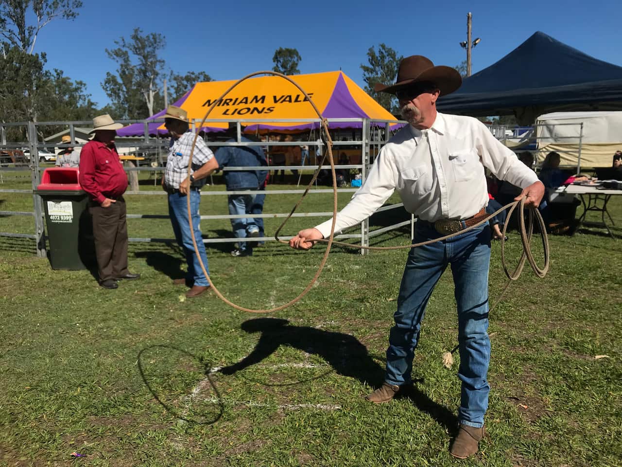 A cowboy practices his lasoo. 