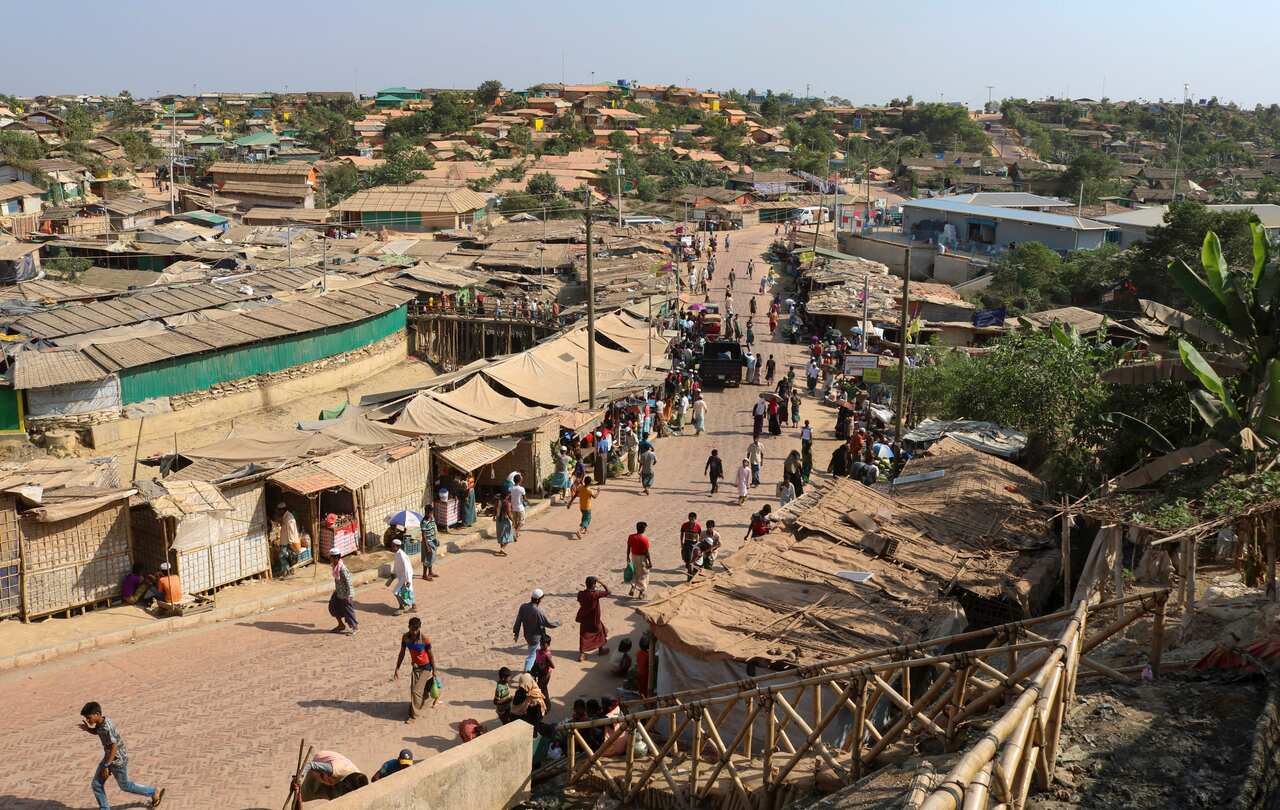 Rohingya refugees walk through one of the arterial roads at the Kutupalong refugee camp in Cox's Bazar, Bangladesh.