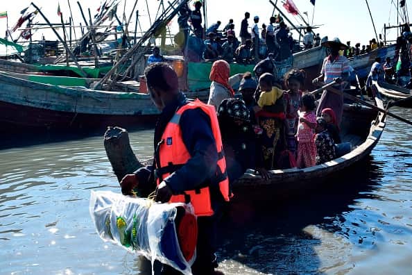 Myanmar Navy personnel escort an earlier group of Rohingya Muslims back to their camp in Sittwe.