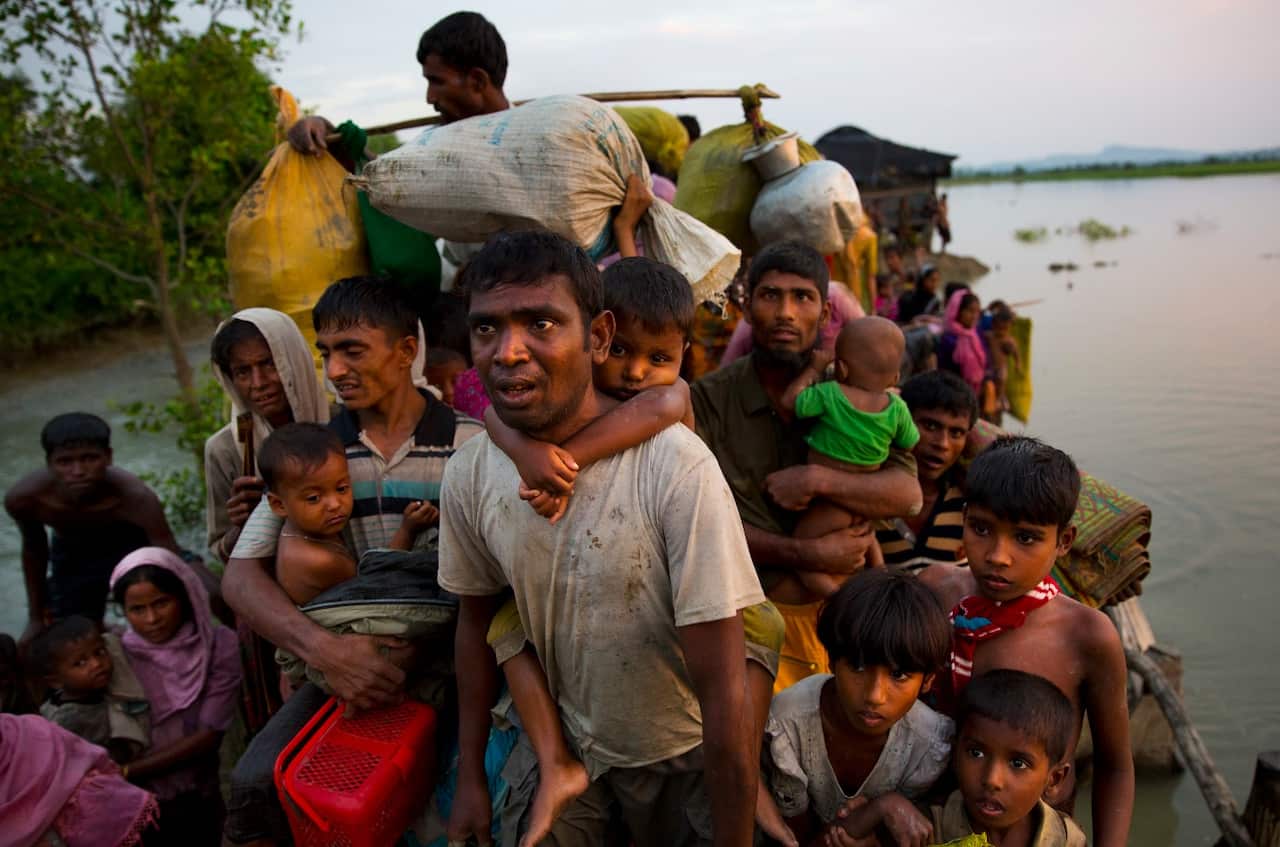 Rohingya Muslims carry their young children and belongings after crossing the border from Myanmar into Bangladesh. Some of them will be heading back.