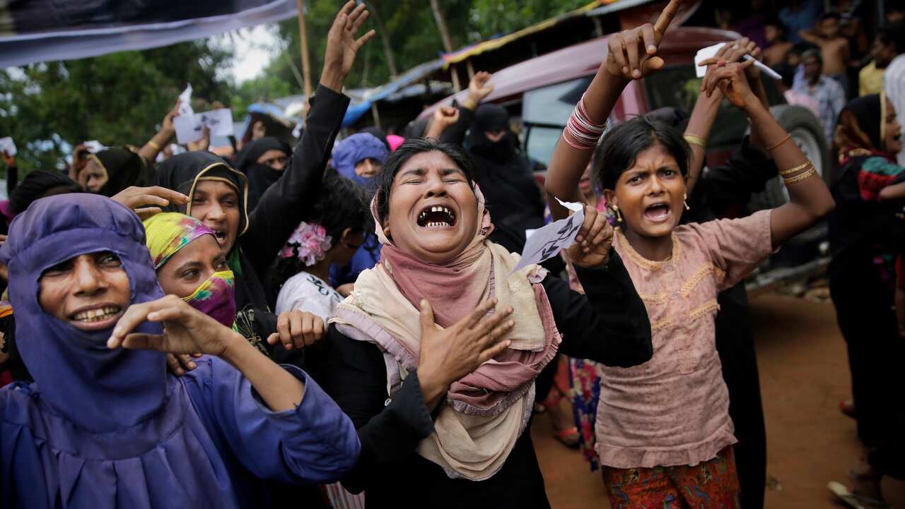 Rohingya women cry as they shout slogans during a protest rally to commemorate the first anniversary of Myanmar army's crackdown.