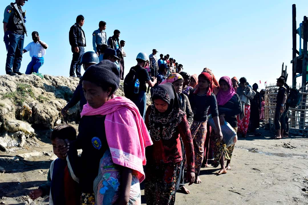 Myanmar Navy personnel escort Rohingya Muslims back to their camp in Sittwe, Rakhine state.