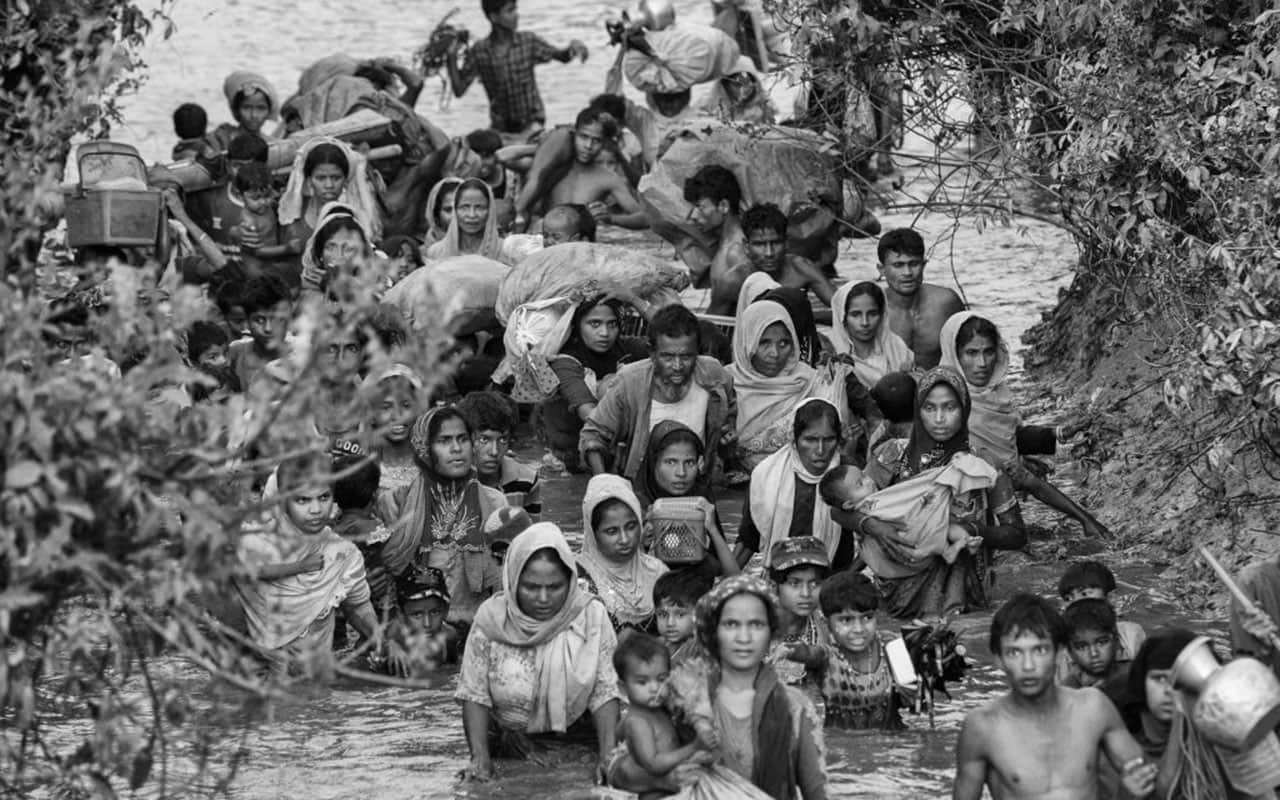 Rohingya Muslim refugees crowd a canal as they flee over the border from Myanmar into Bangladesh