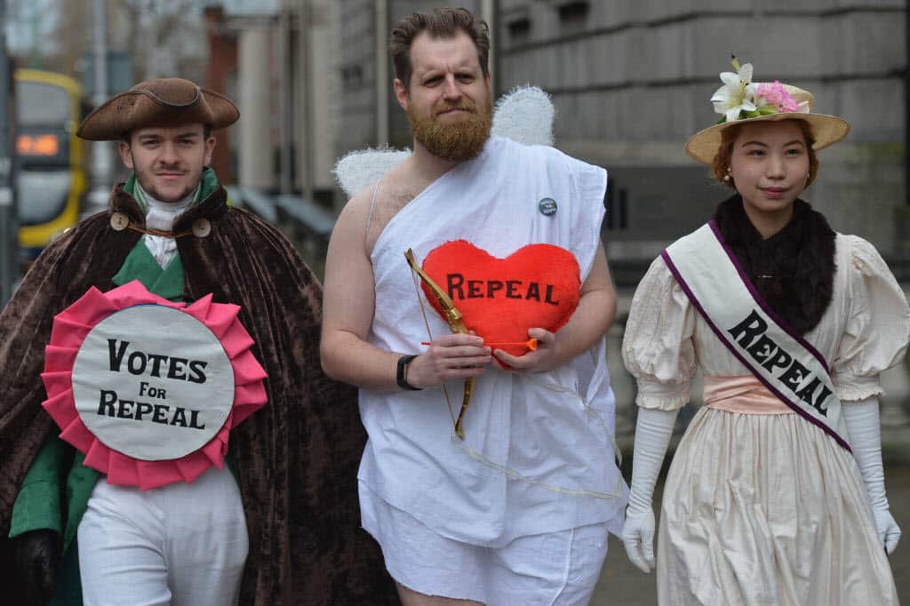 Abortion Rights campaigners, (Left to Right) Adam Murray, Lute Alraad and Morgan Maher, protest outside Leinster House in Dublin