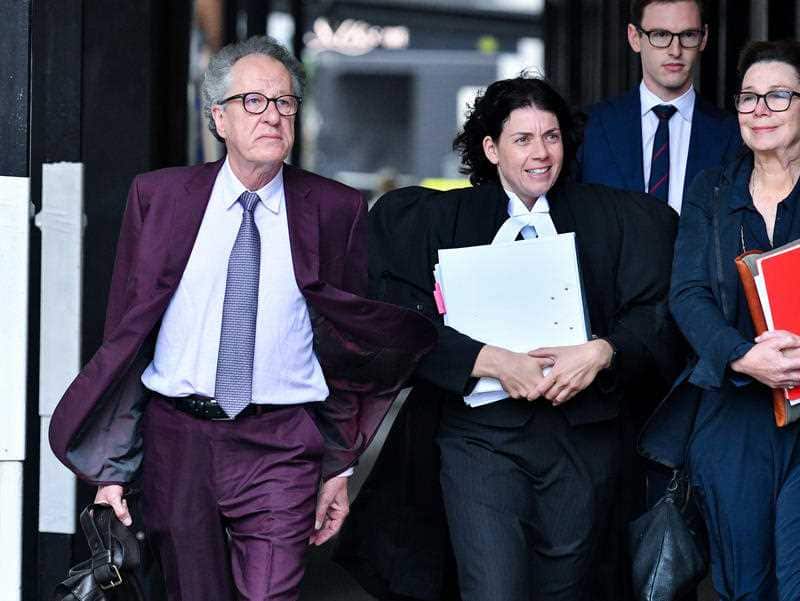 Australian actor Geoffrey Rush (left) arrives at the Federal Court in Sydney on Wednesday.