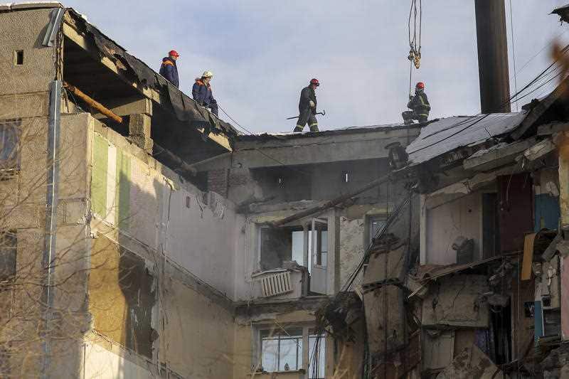 Rescue workers inspect the damaged building in Magnitogorsk, a city of 400,000 people, about 1,400 kilometers southeast of Moscow, Russia.