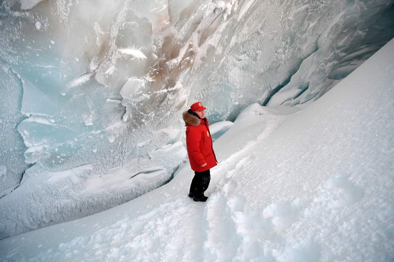 Russian President Vladimir Putin inspects a cavity in a glacier on the Arctic Franz Josef Land archipelago.