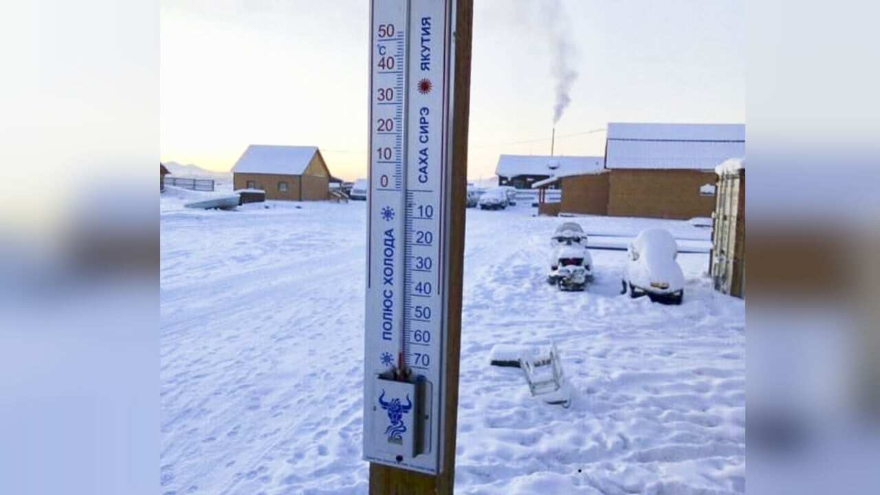 The thermometer shows the temperature dropped to -65 degrees in Tomtor village.