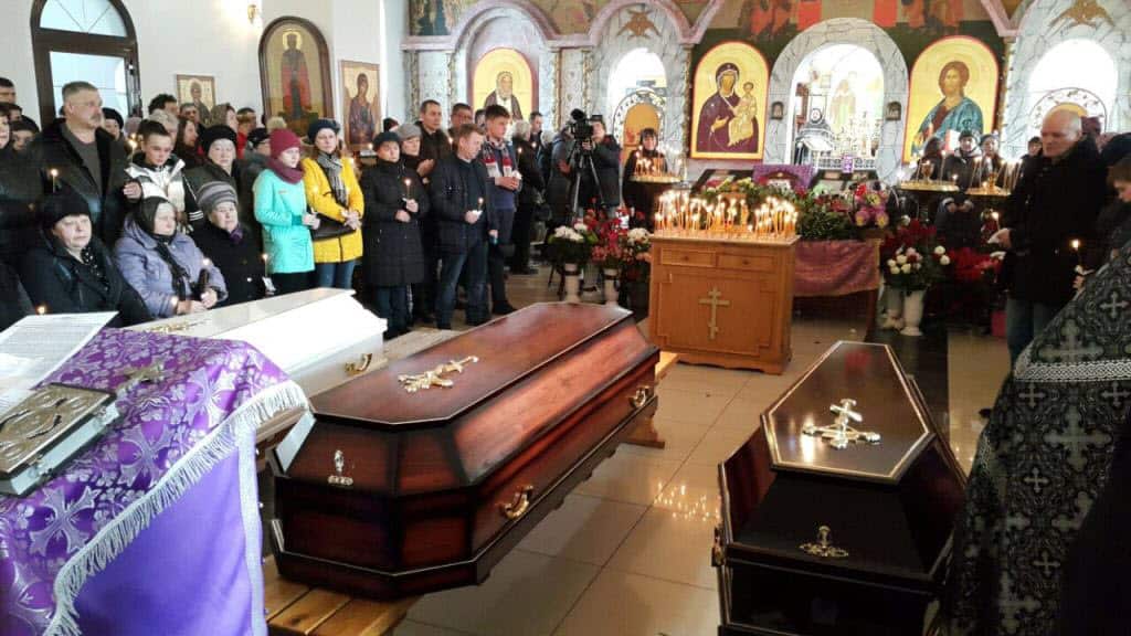 People attend a commemorative ceremony held at a church for the victims of deadly shopping mall fire on Monday that killed 64 people, in Kemerovo.