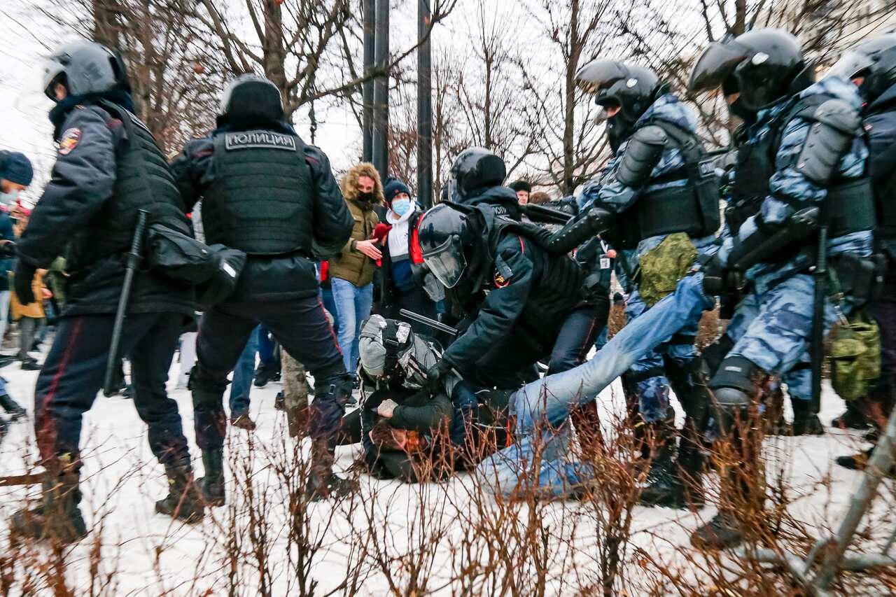Riot police detain a demonstrator with a bloody face during a protest against the jailing of Alexei Navalny in Pushkin square in Moscow, Russia.