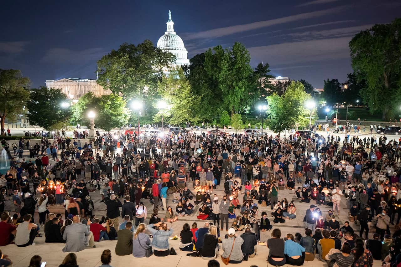 Mourners gather on the steps of the US Supreme Court after Justice Ruth Bader Ginsburg died from pancreatic cancer in Washington, DC, USA, 
