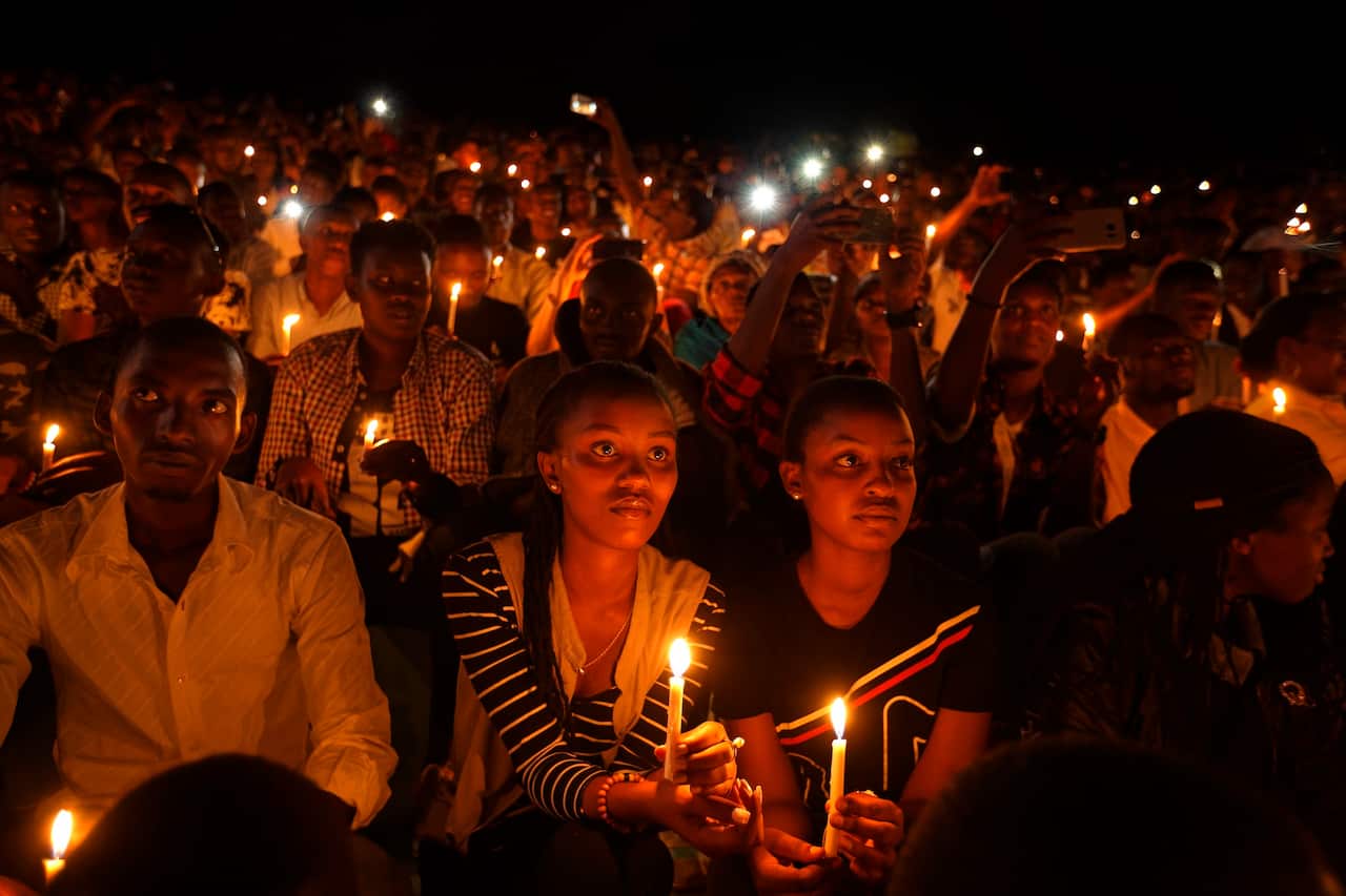 People in Rwanda attend a candlelit vigil during a memorial service marking 25 years since the genocide on 7 April 2019.