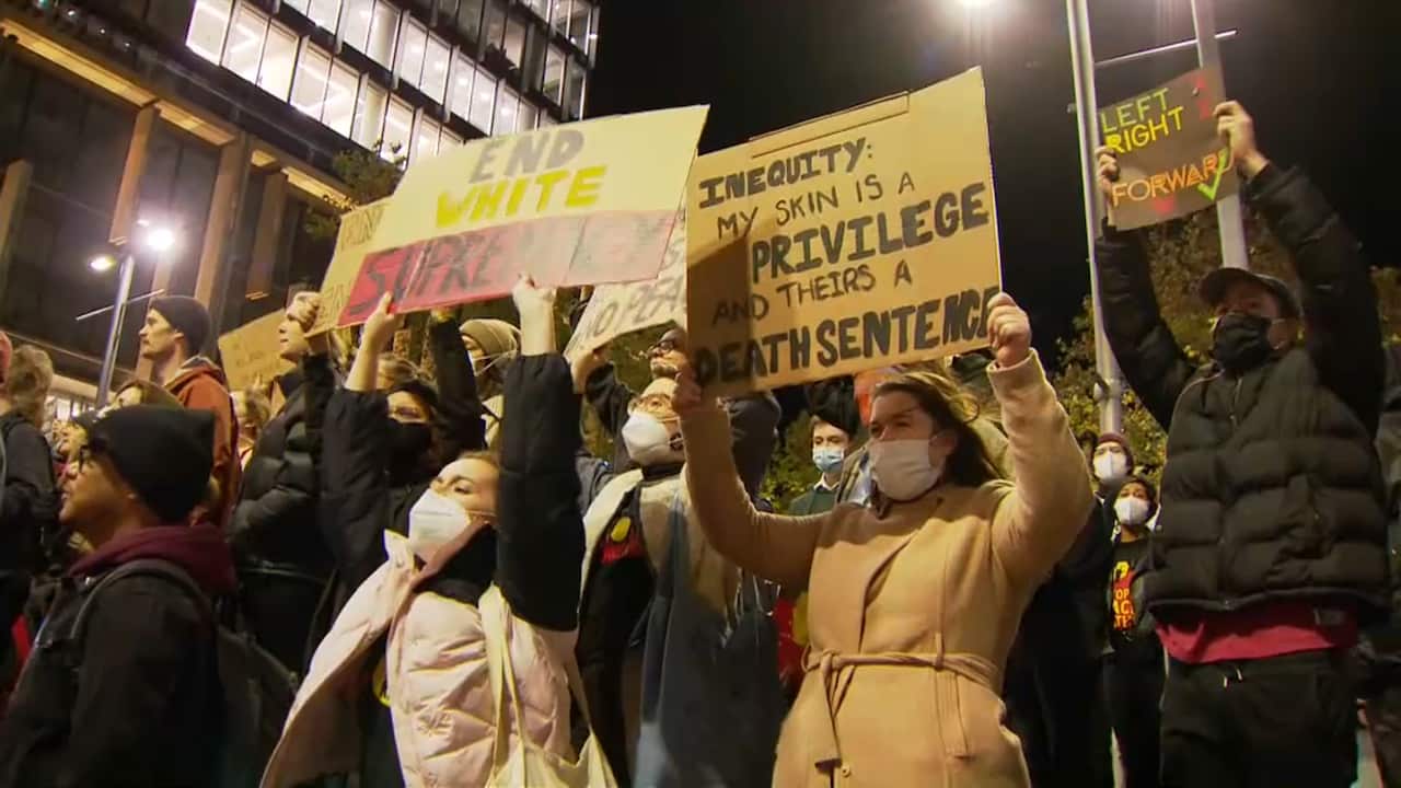 Protesters holding signs at Martin Place