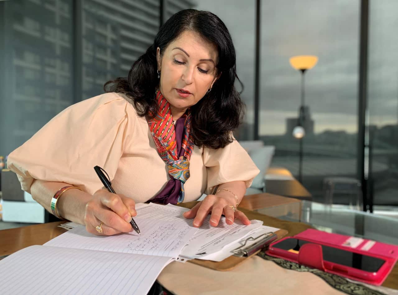 Safaa Hakim counselling a client by phone.