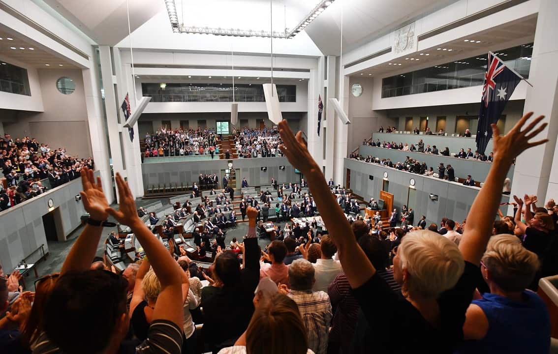 Members celebrate before the passing of the Marriage Amendment Bill in the House of Representatives at Parliament House in Canberra, Thursday, December 7, 2017. (AAP Image/Mick Tsikas) NO ARCHIVING