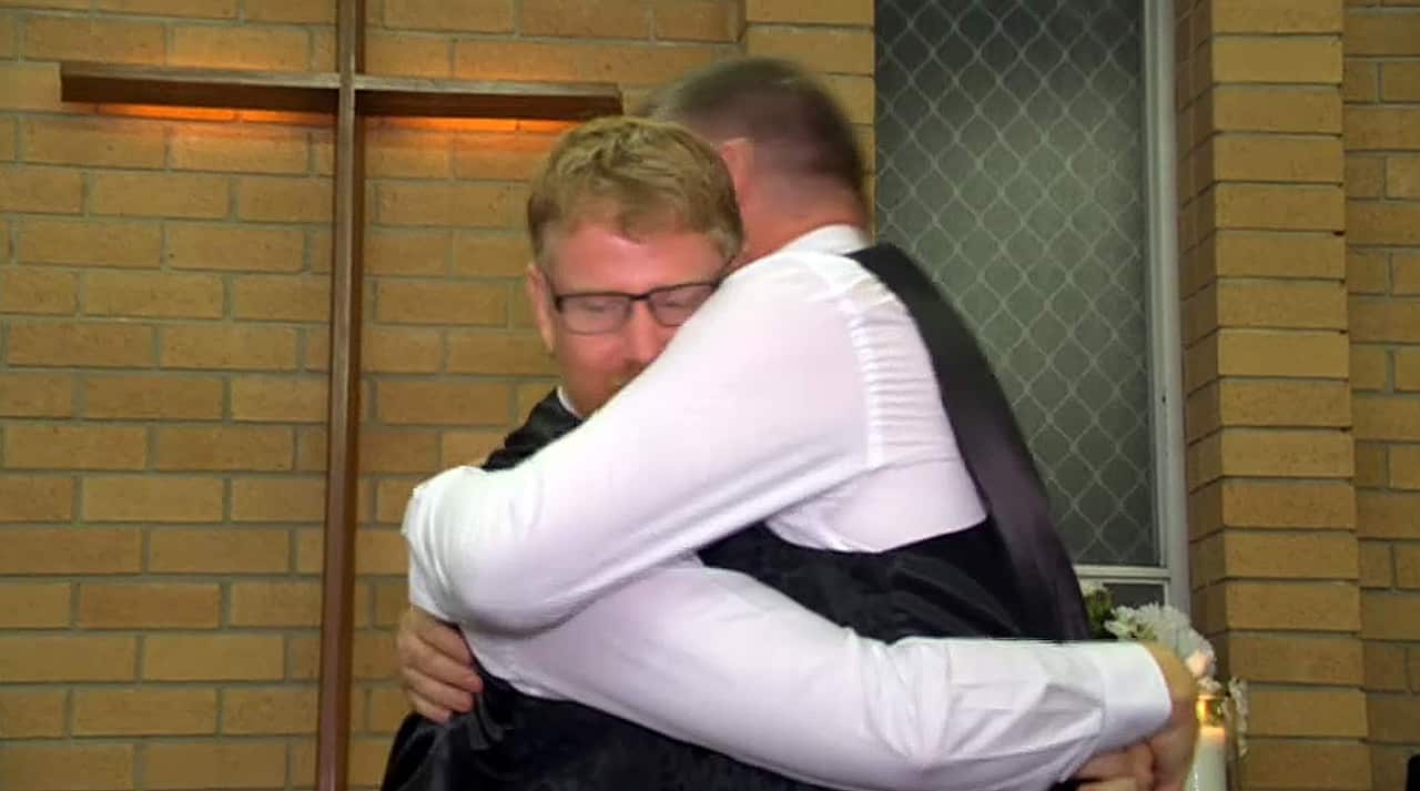The happy couple embrace after their ceremony.