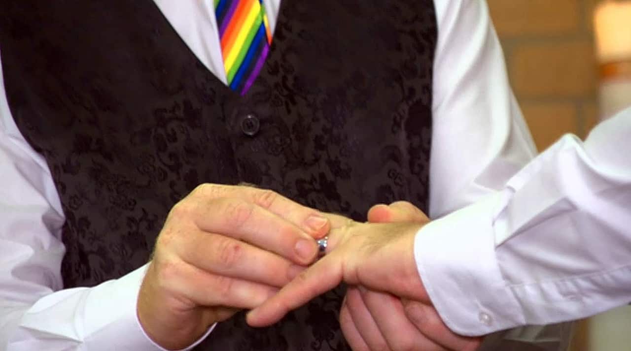 Marc and Alan exchange wedding bands.