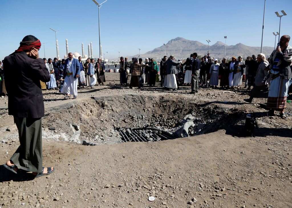 Residents inspect damage after airstrikes launched by the Saudi-led coalition in Sanaa, Yemen, on 24 December, 2021.