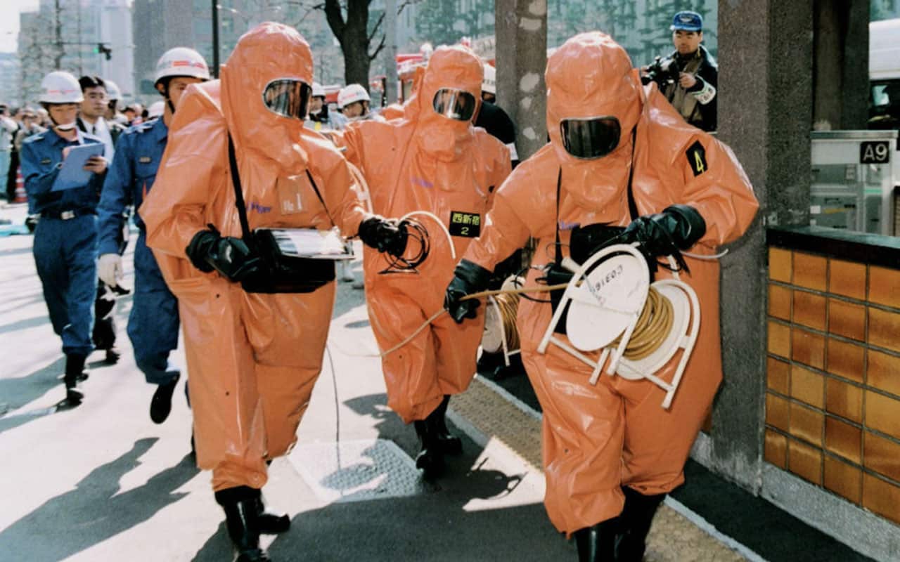 A squad from the Tokyo Fire Department in protective suits, in this file photo taken on March 20, 1995, working near Kasumigaseki Station in Tokyo