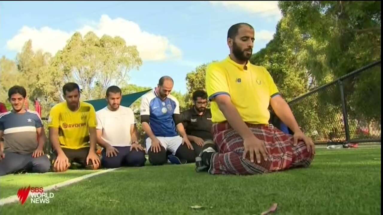 Saudi Arabia fans pray at a local football match in Sydney.