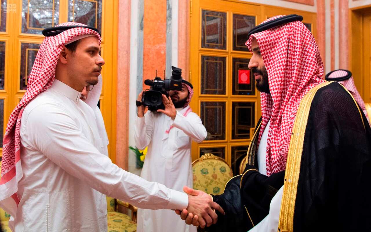 Saudi Crown Prince Mohammed bin Salman, right, shakes hands with Salah Khashoggi the son of slained journalist Jamal Khashoggi.