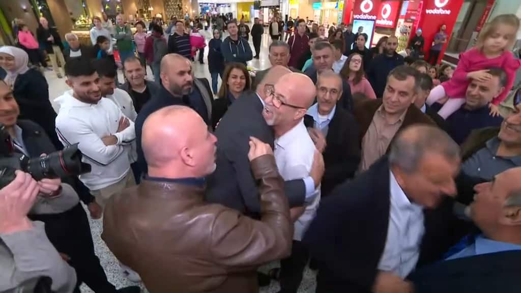 Mr Abbas is surrounded by friends and family after touching down in Sydney.