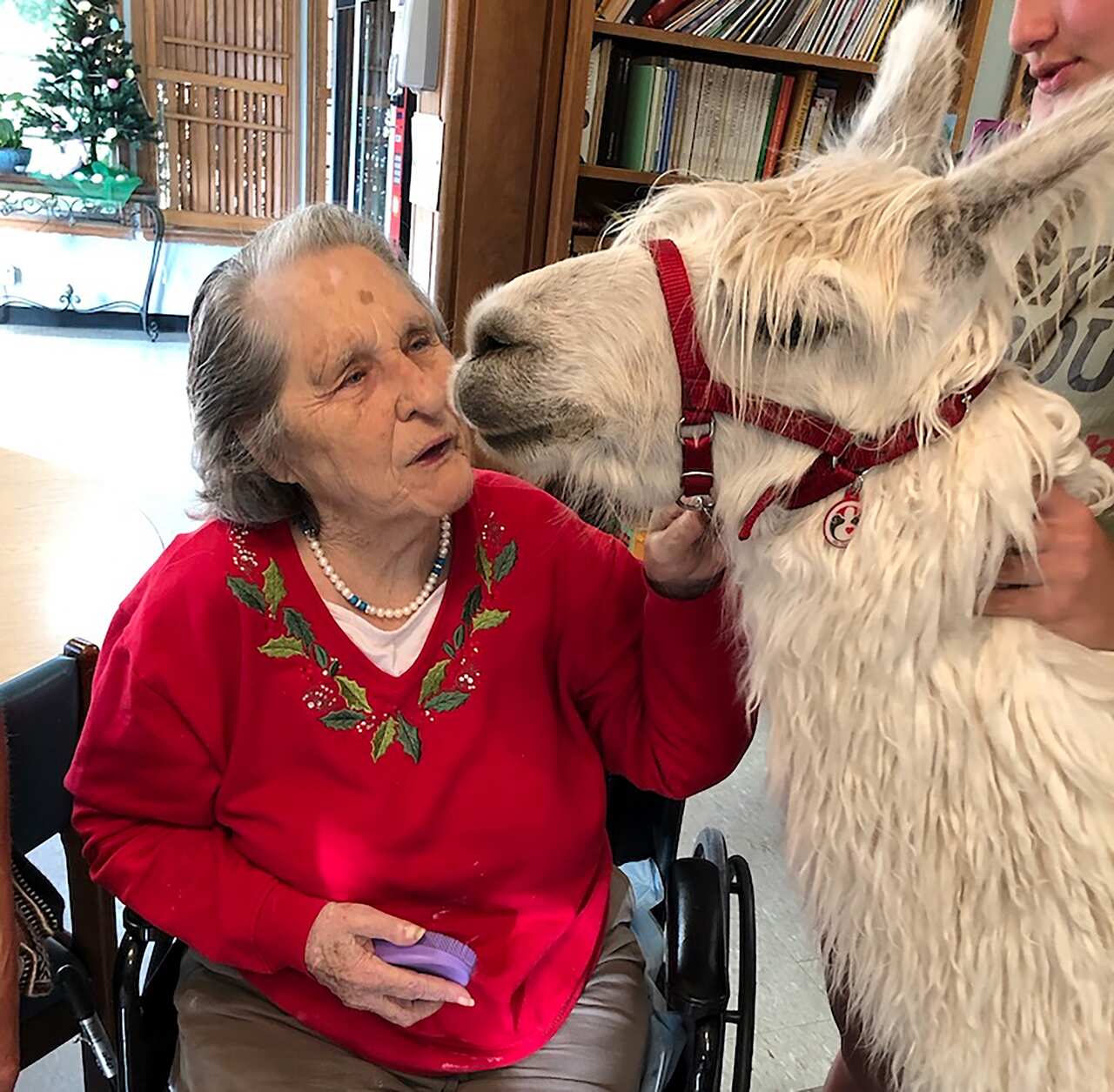 Jean Wyatt greets Tic at the Stockdale Residence and Rehabilitation Center in Stockdale, Texas, in April. (Jennifer Kingson via The New York Times)
