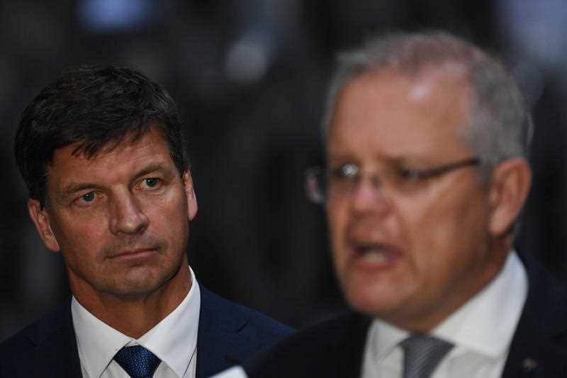 Minister for Energy and Emissions Reduction Angus Taylor listens as Prime Minister Scott Morrison.