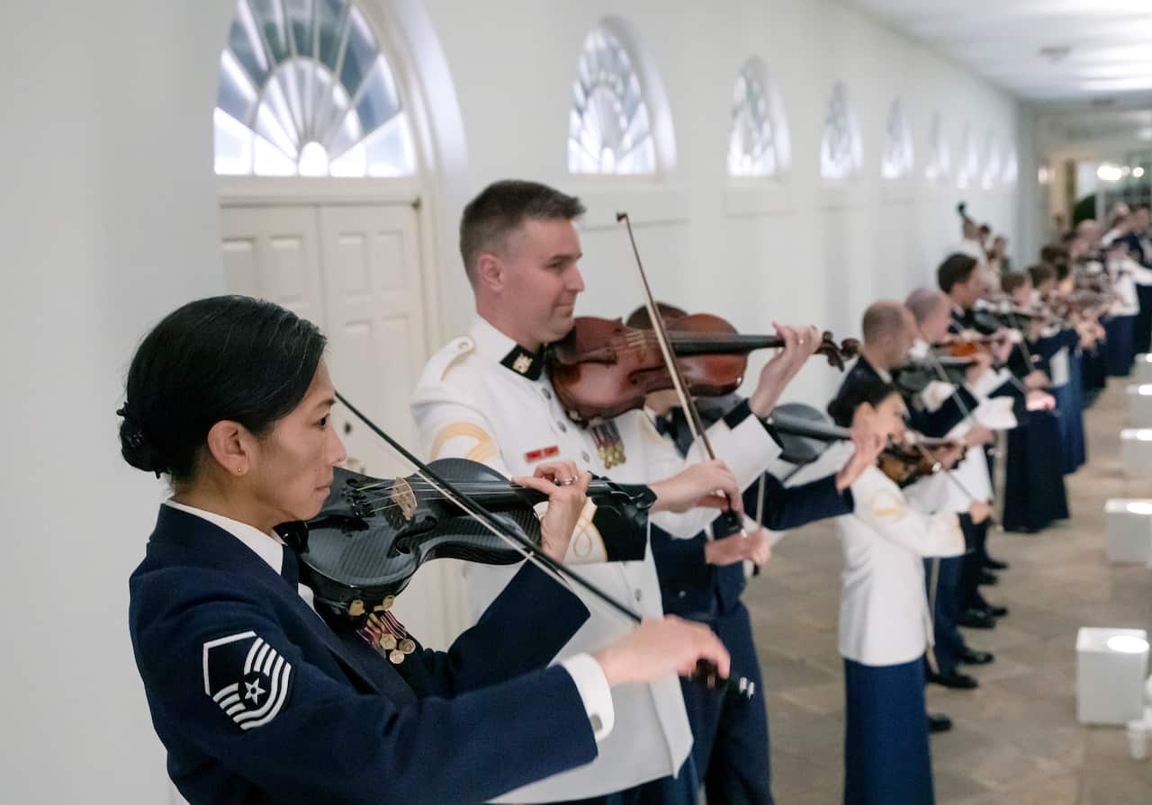 Members of a US military string band play along the West Wing Colonnade. 