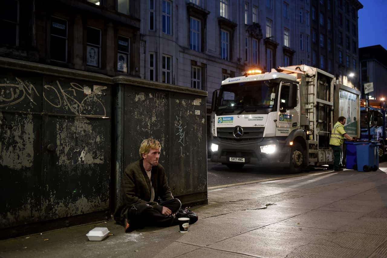 James Muir, a 33-year-old heroin user, begging in Glasgow, Scotland, July 23, 2019. (Mary Turner/The New York Times)